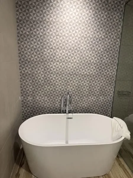 Bathroom features: freestanding bathtub, chrome faucet, geometric patterned tile wall, light grey wall tiles, wood-look flooring, glass shower enclosure; style: modern.