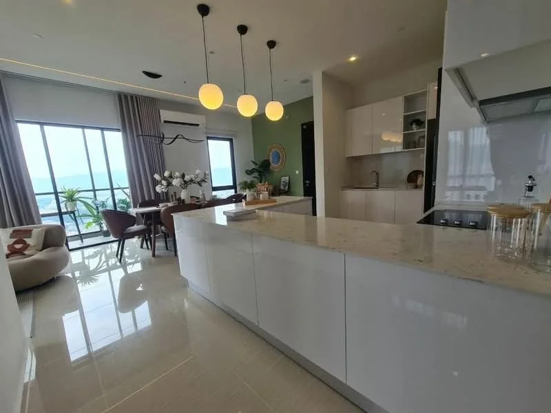Kitchen features: white cabinetry, marble countertop, stainless-steel sink, chrome pull-down faucet, built-in oven, induction hob, recessed downlights, floor-to-ceiling windows, open-plan layout, polished tile flooring; style: modern; view: sea. Dining features: 6-seater dining table, upholstered dining chairs, decorative vase with flowers, wall-mounted artwork; style: modern; view: sea.