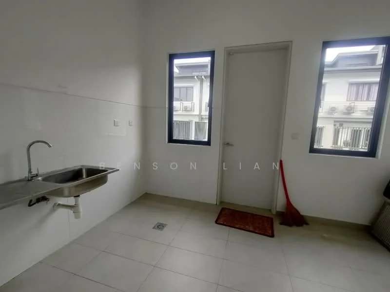 Laundry features: single-bowl stainless-steel sink, white tiled walls, light grey tiled flooring, two windows, door leading to outside, red floor mat, broom, drainage grate in floor.