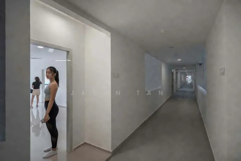 Hallway features: white painted walls, grey carpet flooring, recessed downlights, doorway leading to another room, wide corridor, smooth ceiling, multiple doorways, natural light from windows; style: modern.