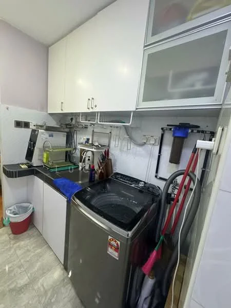 Laundry features: front-load washing machine, built-in cabinets, black countertop, white upper cabinets, sink with faucet, hose rack, cleaning supplies, waste bin, grey tiled flooring; style: modern.