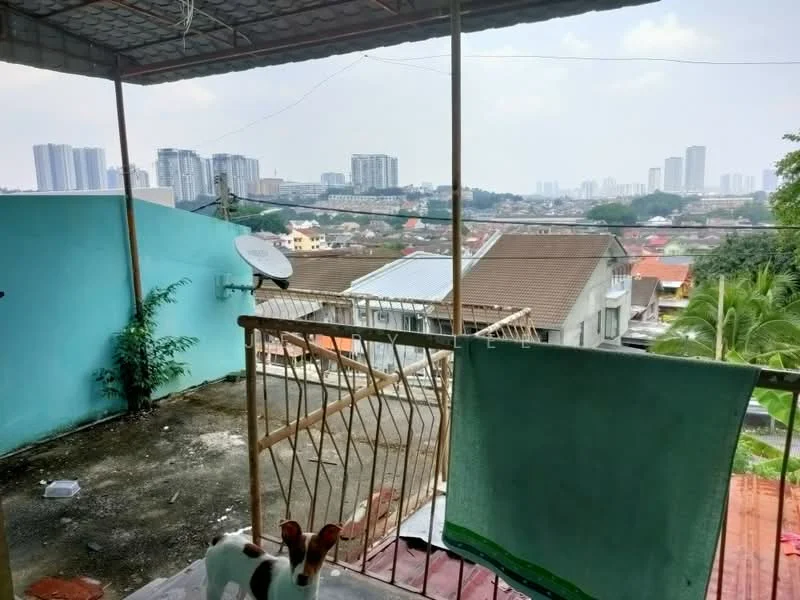 Room features: balcony, metal railing, concrete flooring, city skyline view, satellite dish, green wall, laundry hanging area, partially covered roof; view: city.