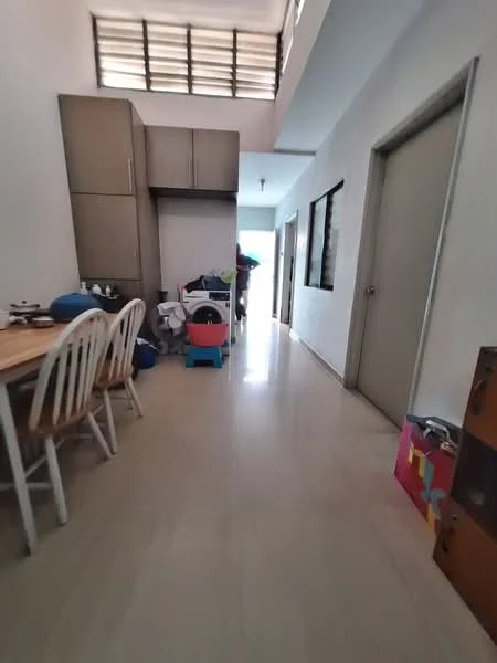 Room features: light-colored tiled flooring, white painted walls, wooden dining table with white chairs, built-in cabinetry in light wood, window with horizontal slats, doorway leading to another room, laundry basket, various items on the floor; style: modern.