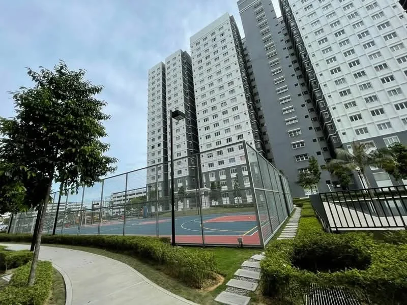 Exterior type: high-rise condominium; features: basketball court, tennis court, manicured landscaping, walking path, multi-storey building, glass facade, balconies, surrounding greenery; style: modern.