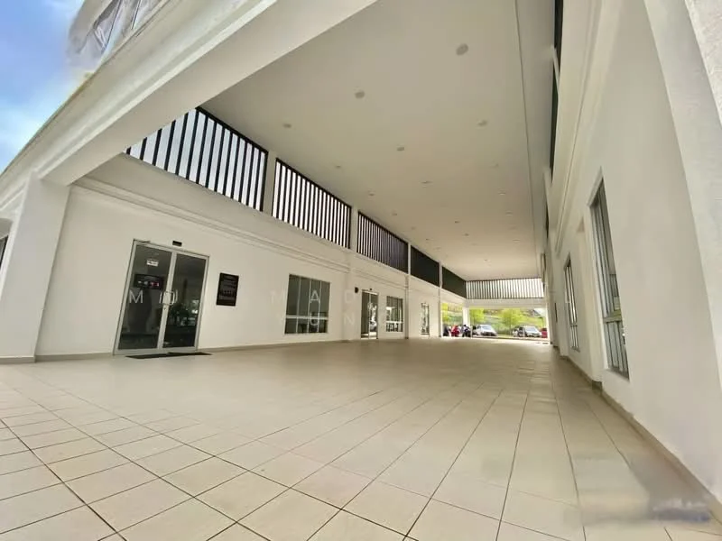 Exterior type: low-rise apartment block; features: white painted facade, flat roof, ground floor entrance, large glass windows, tiled flooring, open-air corridor, recessed lighting, vertical slatted screens, manicured landscaping visible in background; style: modern.