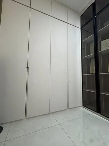 Room features: white cabinetry with flat-panel doors, built-in wardrobe, glass shelving unit, marble tile flooring, neutral wall colour, minimalist design; style: modern.