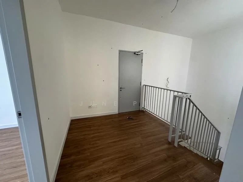 Room features: wooden flooring, white painted walls, metal railing, staircase, door, light fixture, unpainted ceiling, baseboard.