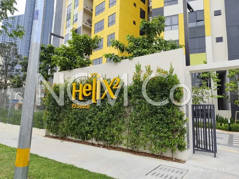 Exterior type: high-rise condominium; features: yellow and grey painted facade, landscaped greenery, modern entrance gate, paved walkway, surrounded by mature trees, signage with 'Helix 2 PJ South', glass windows, balconies visible on upper floors; style: modern.