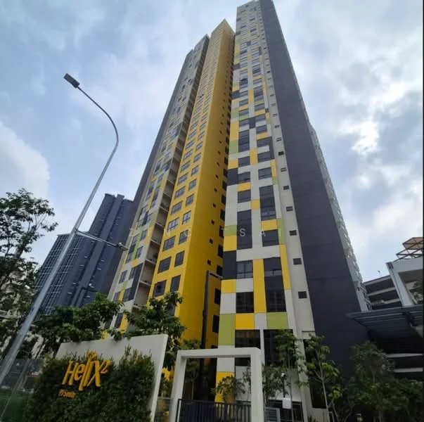 Exterior type: high-rise condominium; features: yellow and black facade, glass windows, recessed balconies, modern architectural design, surrounded by greenery, multiple storeys, prominent signage at entrance; style: modern.