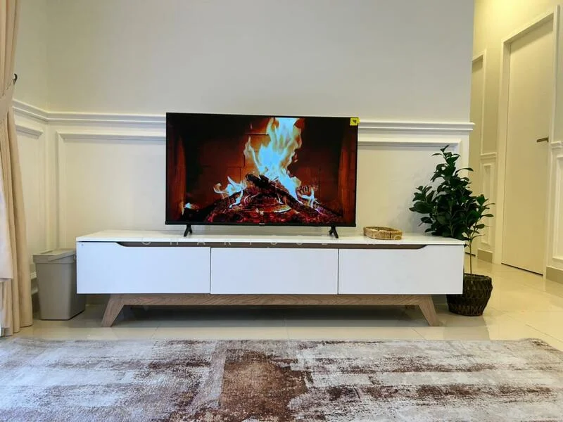 Living features: white TV console with wooden legs, wall-mounted TV, decorative plant in a pot, area rug with abstract pattern, cream painted walls, crown moulding, large window with sheer curtains, tile flooring; style: modern.