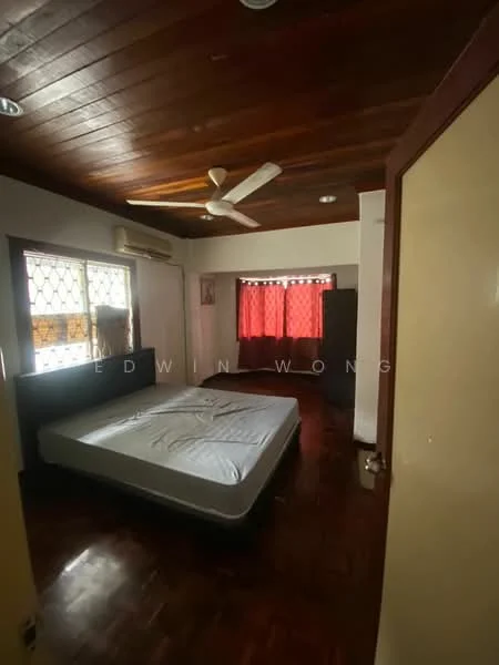 Bedroom features: wooden flooring, brown wooden ceiling, 5-blade ceiling fan, wall-mounted split AC, large window with grid pattern, red curtains, empty bed frame, built-in wardrobe, decorative wall art.