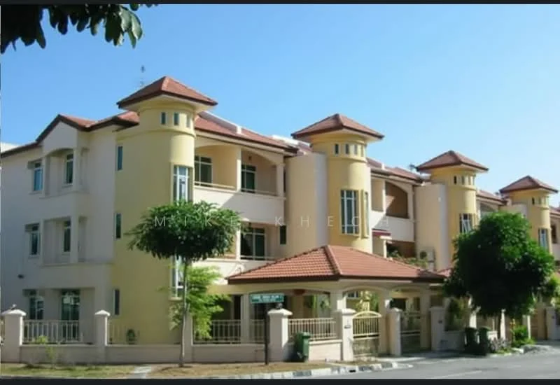 Exterior type: low-rise apartment block; features: yellow painted facade, red tiled roof, multiple balconies, arched windows, landscaped garden with trees, fenced perimeter, driveway with interlocking pavers, two-storey building, main entrance gate; style: modern.