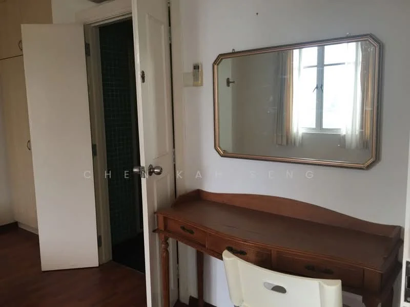 Room features: wooden flooring, white painted walls, mirror on wall, wooden vanity table, white chair, door leading to another room, window with sheer curtains, built-in wardrobe with light wood finish.