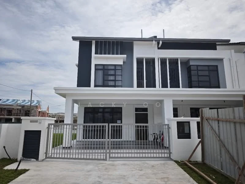 Exterior type: semi-detached house; features: two-storey structure, white painted facade, grey accent walls, large black-framed windows, metal railing at the entrance, concrete driveway, manicured lawn, gated entry, flat roof, surrounded by construction, modern architectural design; style: modern.