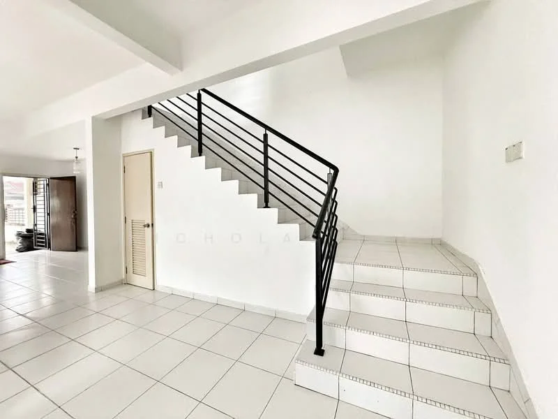 Room features: white painted walls, white tiled flooring, metal railing on staircase, staircase with white steps, open space layout, natural light from windows, door leading to another room, light fixture on ceiling; style: modern.