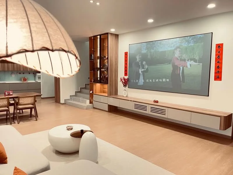 Living features: light wood flooring, white walls, built-in entertainment unit with TV, recessed lighting, large wall-mounted screen, decorative wall art, coffee table with rounded shape, sofa with orange cushions, open shelving unit, steps leading to another area; style: modern.