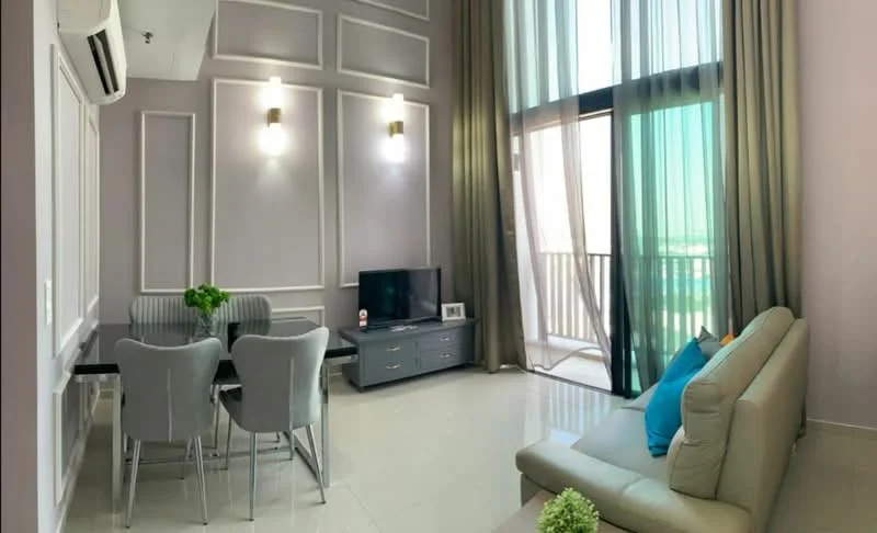 Living features: light grey fabric sofa, blue decorative cushion, glass coffee table, TV console, wall-mounted TV, dining table with 4 grey upholstered chairs, white painted walls with panel moulding, floor-to-ceiling windows, sheer curtains, recessed downlights, air conditioning unit, cream tiled flooring; style: modern; view: city.