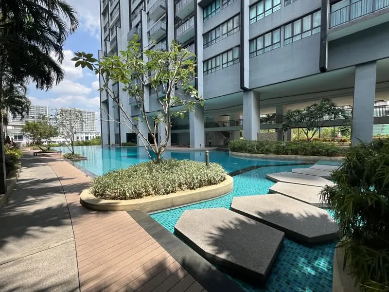 Exterior type: high-rise condominium; features: infinity pool, pool deck with loungers, landscaped garden, mature trees, stone-paved walkway, water feature, surrounded by greenery; style: modern.