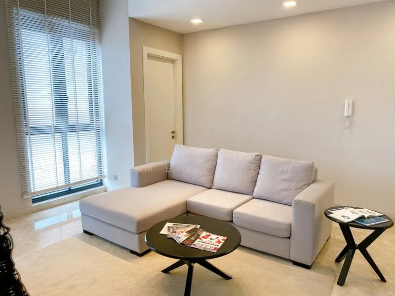 Living features: L-shape sectional sofa in light grey, round black coffee table, cream marble flooring, floor-to-ceiling windows with blinds, white painted walls, recessed downlights, wall-mounted intercom, decorative magazines on table; style: modern.