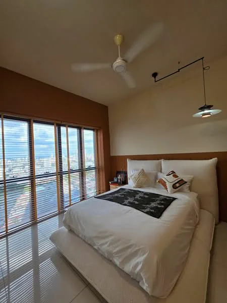 Bedroom features: king-size bed, white bedding, decorative throw pillow, wooden headboard, ceiling fan, recessed downlight, floor-to-ceiling windows, wooden window blinds, nightstand, framed artwork, laminate flooring, accent wall in brown, white painted walls; style: modern; view: city.