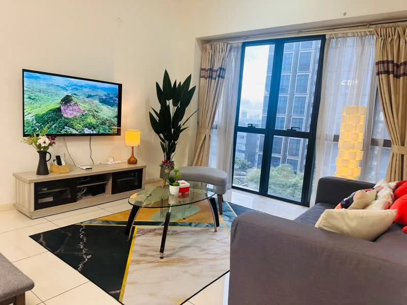 Living features: grey fabric sofa, glass coffee table, area rug with geometric pattern, wall-mounted TV, TV console with storage, floor-to-ceiling windows, sheer curtains, decorative houseplant, table lamp, light fixture, decorative cushions; style: modern; view: city.