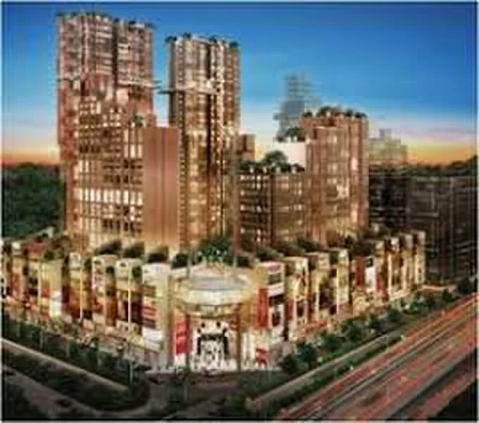 Exterior type: high-rise condominium; features: glass curtain wall, exposed concrete facade, recessed balconies, feature lighting at night, multiple towers, surrounded by greenery, urban context with main road, landscaped entrance, commercial spaces at ground level; style: modern.