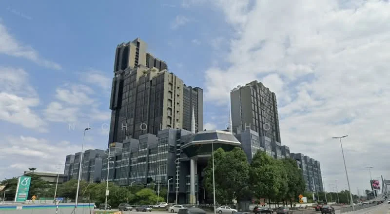 Exterior type: high-rise condominium; features: glass curtain wall, exposed concrete facade, recessed balconies, multiple storeys, landscaped greenery, surrounded by mature trees, urban context with main road access; style: modern.
