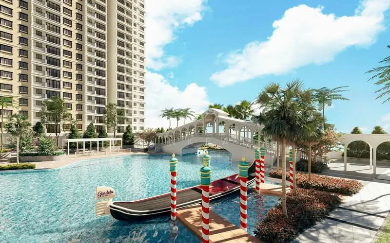 Exterior type: high-rise condominium; features: swimming pool with water features, landscaped garden with tropical plants, decorative bridge over the pool, gondola-style boat in the pool, palm trees, manicured lawn, pool deck with loungers, residential building facade, clear blue sky; style: modern.