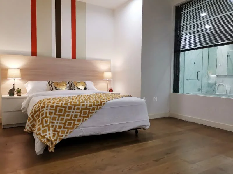 Bedroom features: king-size bed with white bedding, upholstered headboard, decorative throw blanket with geometric pattern, two bedside lamps with shades, wooden flooring, striped accent wall in red and beige, large window with blinds, en-suite bathroom visible through glass door, decorative pillows, nightstand with plant; style: modern.