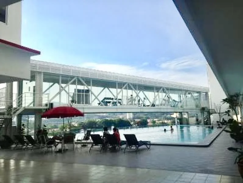 Exterior type: high-rise condominium; features: infinity pool, pool deck with loungers, covered walkway, outdoor seating area, red umbrella, landscaped surroundings, city skyline view, glass railing, white painted facade, modern architecture; style: modern.