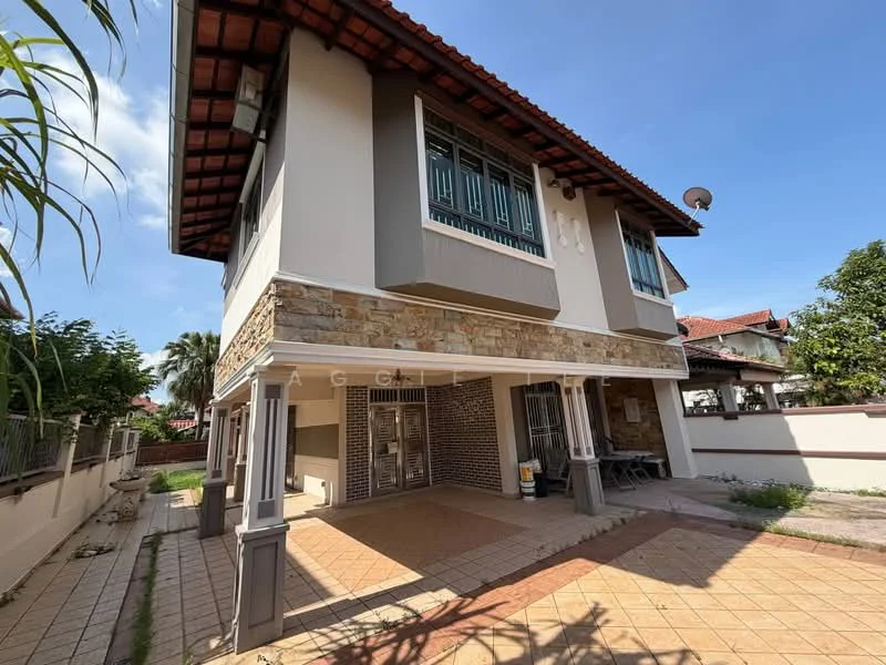Exterior type: detached bungalow; features: stone cladding on lower facade, grey painted upper facade, red tiled roof, covered porch area, windows with metal grilles, outdoor seating area, manicured garden, paved walkway, satellite dish on roof, surrounding greenery; style: modern.