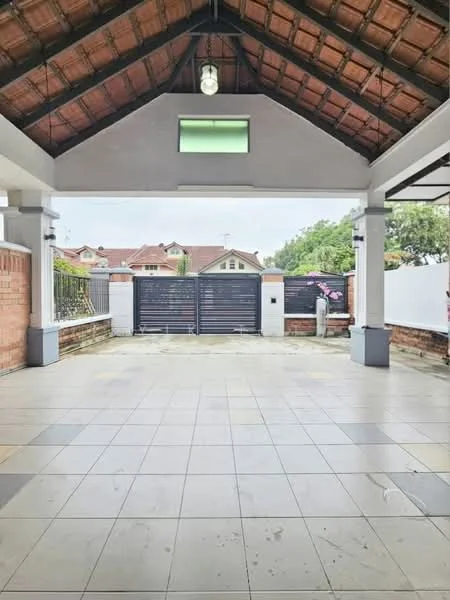 Exterior features: tiled flooring, high ceiling with wooden beams, overhead light fixture, brick wall, gate with horizontal slats, surrounding greenery, paved driveway, fenced perimeter; style: traditional.