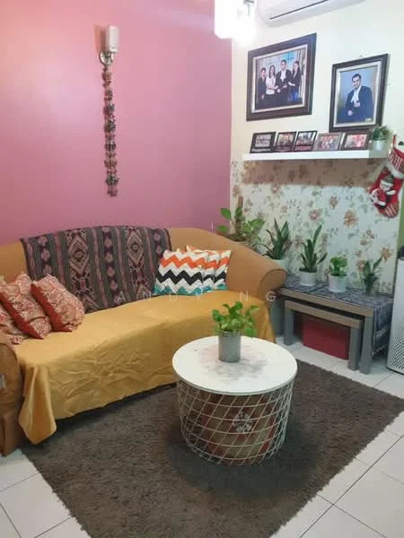 Living features: 3-seater fabric sofa in beige with patterned cushions, yellow throw blanket, round coffee table with metal base, area rug with brown color, wall-mounted shelf with decorative photos, green potted plants, pink painted walls, floral wallpaper, wall sconce lighting, air conditioning unit; style: contemporary.