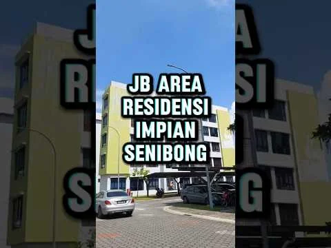 Exterior type: low-rise apartment block; features: yellow painted facade, white window frames, covered parking area, paved driveway, landscaped surroundings, multiple storeys, balconies on upper floors, clear blue sky, car parked in front; style: modern.