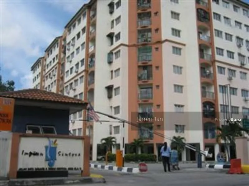 Exterior type: mid-rise condominium; features: orange and white painted facade, balconies with glass railings, security gate with guard house, landscaped entrance with palm trees, parking lot with marked spaces, surrounded by greenery; style: modern.