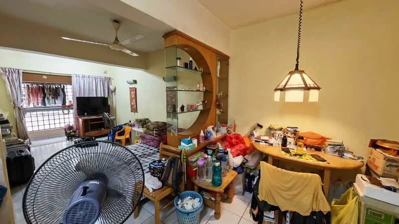 Room features: ceiling fan, hanging pendant light, wooden dining table, wooden chairs, shelves with decorative items, various household items on table, plastic storage basket, tile flooring, light yellow painted walls, television on stand, curtains on window, open doorway leading to another room.