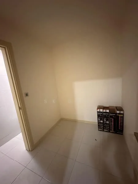 Room features: white painted walls, tile flooring, corner space, empty room, no visible windows, no visible furniture, light source from doorway, stack of boxes.