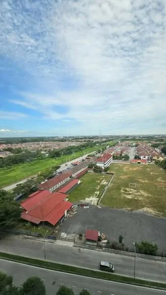 Exterior features: red pitched roof, single-storey buildings, open green space, paved road, surrounding greenery, urban residential area, clear blue sky, clouds; style: modern.
