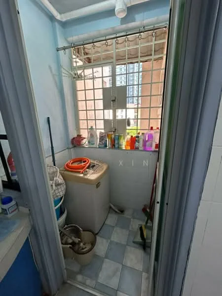 Laundry features: washing machine, sink, window with metal grille, blue painted walls, light blue tiled flooring, shelves with cleaning supplies, clothes drying rack, broom and cleaning tools.
