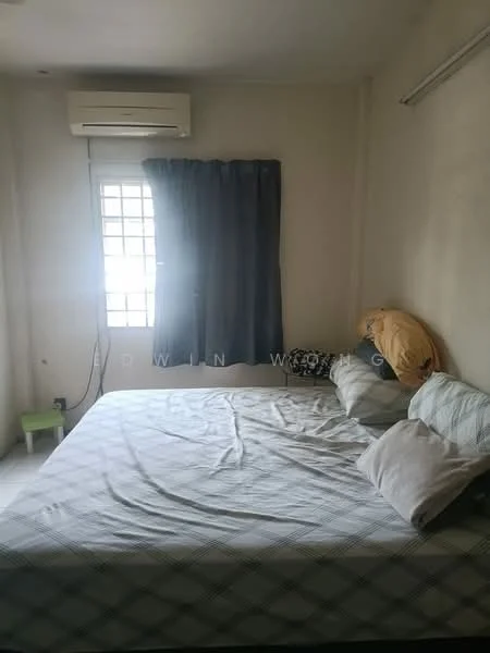 Bedroom features: queen-size bed, light blue checkered bedspread, 2 pillows, 1 wall-mounted split AC, window with grid pattern, blue curtains, cream painted walls, green bedside table, teddy bear on bed.