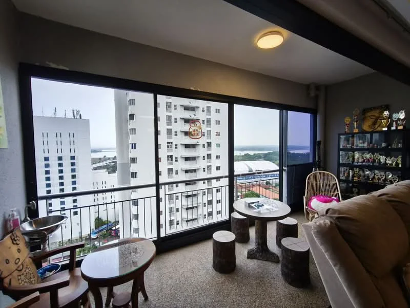 Living features: large floor-to-ceiling windows, city skyline view, grey painted walls, exposed concrete ceiling, light fixture on ceiling, wooden coffee table, stool seating, decorative shelves with trophies, beige fabric sofa, hanging rattan chair; style: modern; view: city.