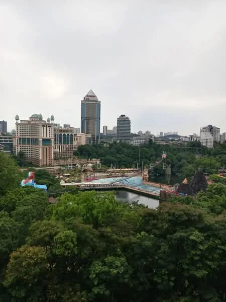 Exterior type: high-rise condominium; features: city skyline view, lush greenery in foreground, amusement park visible, water body in view, modern architectural design, multiple high-rise buildings, cloudy sky; style: modern.