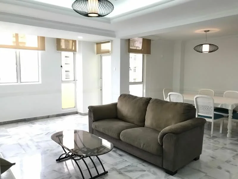 Living features: 3-seater fabric sofa in beige, glass coffee table with metal legs, marble tile flooring, white painted walls, recessed downlights, floor-to-ceiling windows, sheer curtains, pendant light fixture, dining area visible in background, open layout; style: modern; view: city.