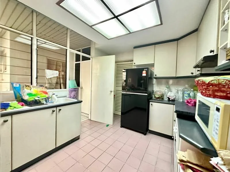 Kitchen features: black fridge, white cabinetry, grey countertop, double-bowl stainless-steel sink, chrome faucet, microwave, tile flooring in pink, window with grid pattern, door leading to outside, storage cabinets, kitchen utensils and cleaning supplies visible.