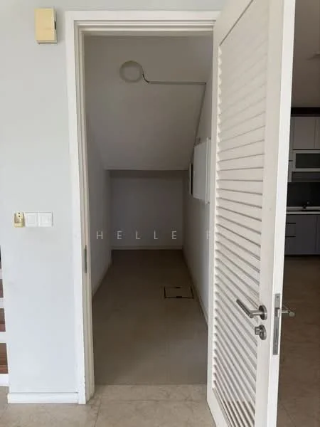 Room features: white painted walls, tile flooring, door with horizontal slats, ceiling light fixture, sloped ceiling, empty space.
