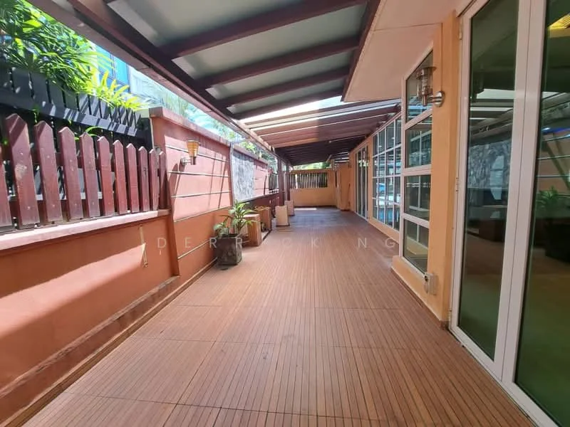 Room features: wooden decking flooring, glass sliding door, exposed beams on ceiling, outdoor lighting fixtures, potted plants, fenced wall, covered awning, open space layout; style: modern; view: garden.