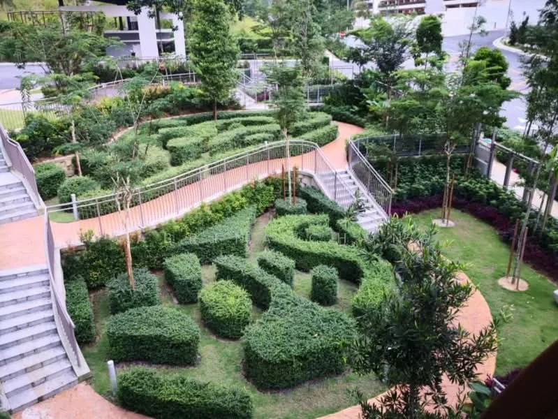 Exterior type: landscape garden; features: manicured hedges, curved pathways, mature trees, flower beds with colorful plants, decorative fencing, green lawn area, stepped stone pathway, surrounding greenery; style: modern.
