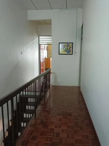 Hallway features: wooden flooring, white painted walls, staircase with wooden railing, framed artwork on wall, natural light from windows, high ceiling, doorway leading to other rooms.