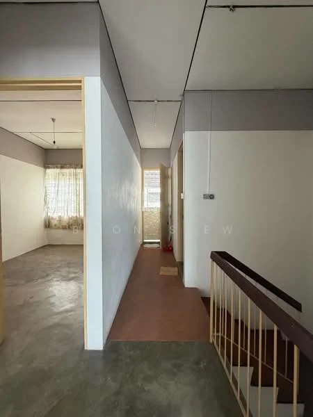Room features: grey painted walls, white painted walls, concrete flooring, natural light from windows, staircase with wooden railing, curtains on window, doorway leading to another room, hallway with access to multiple rooms; style: minimalist.
