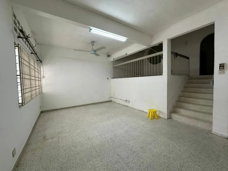 Living features: white painted walls, speckled tile flooring, ceiling fan, large window with metal grille, staircase leading to upper floor, yellow plastic stool, recessed lighting, open layout.
